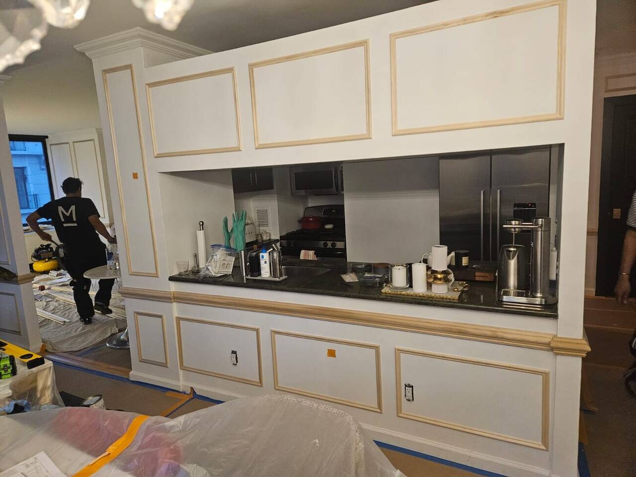 Custom kitchen cabinetry with mirrored backsplash, NYC apartment renovation
