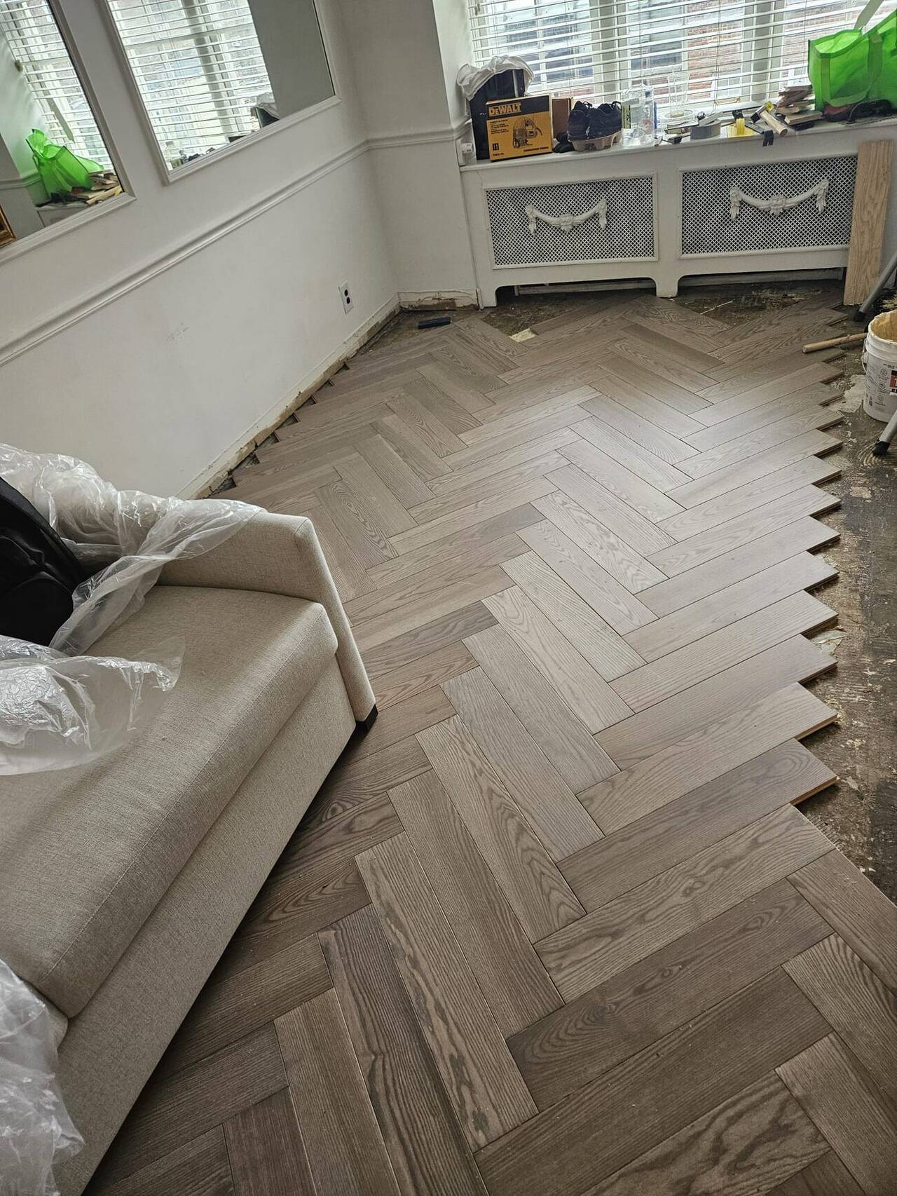 Herringbone hardwood flooring installation in a New York City apartment